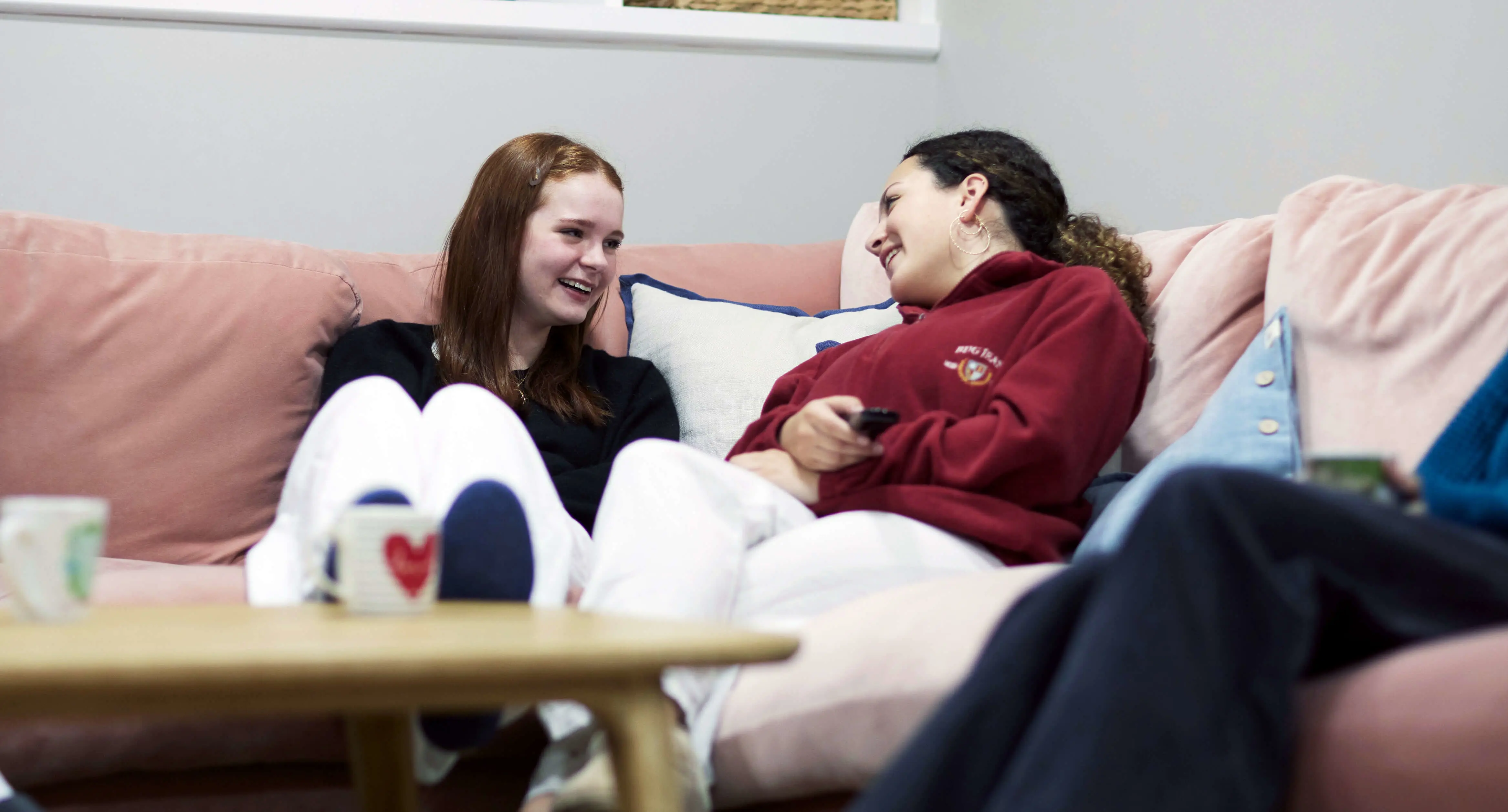 St Swithun's girls on sofa in boarding house at Winchester private school 