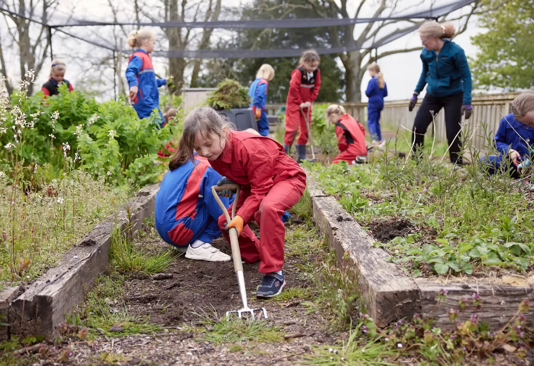 Young students outside learning in the garden at St Swithun's School for girls in Hampshire 