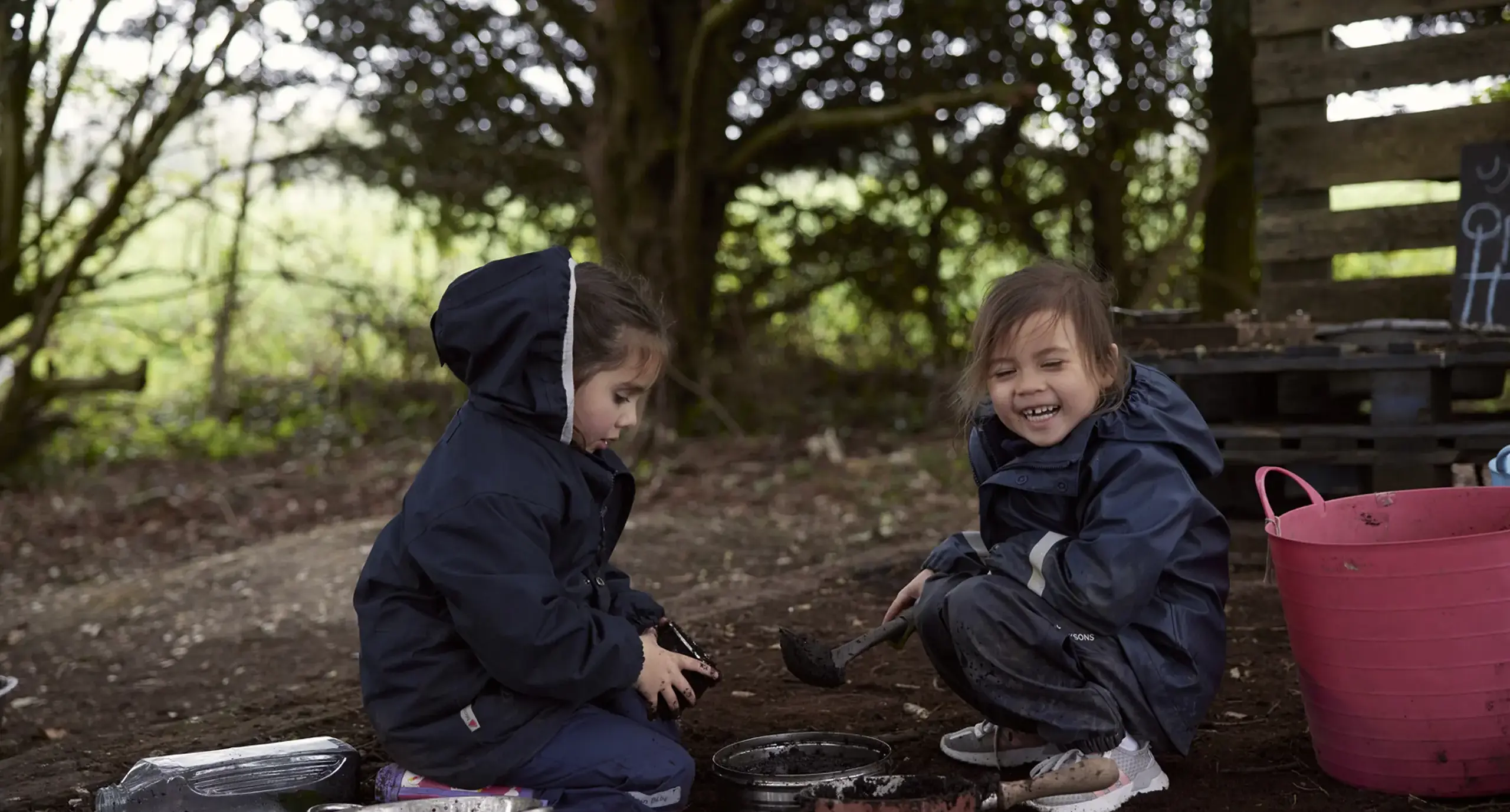 Young students outside learning in the forest at St Swithun's School for girls in Hampshire 