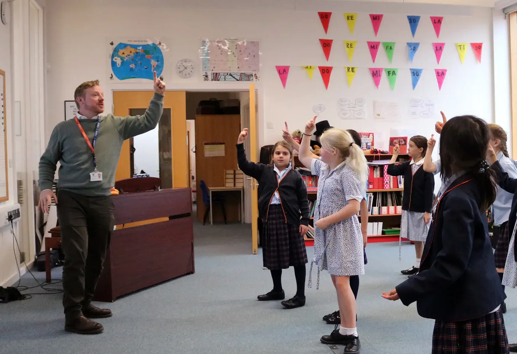 Students in lesson singing with teacher at St Swithun's private School for girls in Winchester