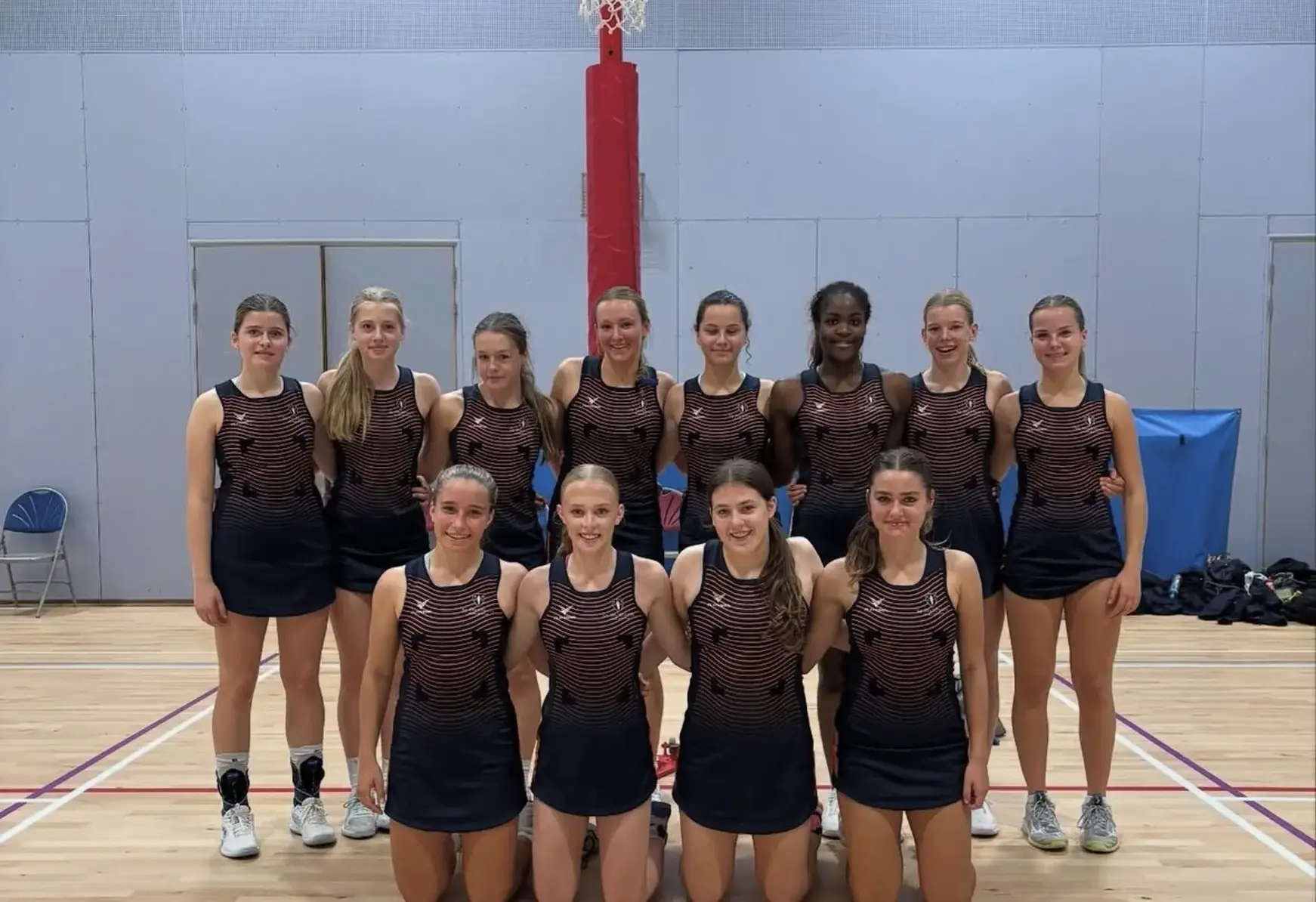 Students at St Swithun's private senior School for girls in Hampshire playing netball indoors