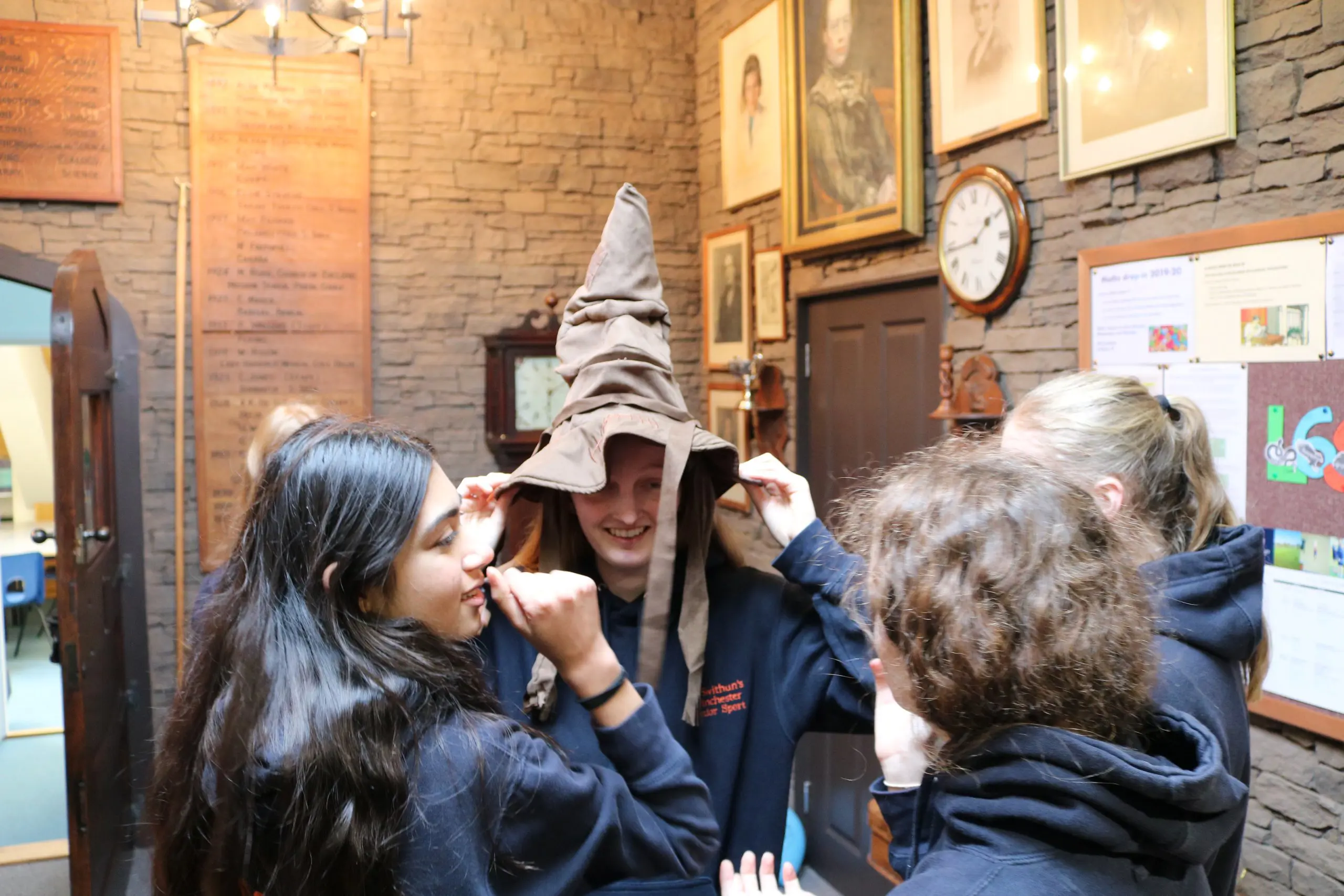 Students try on a wizard hat