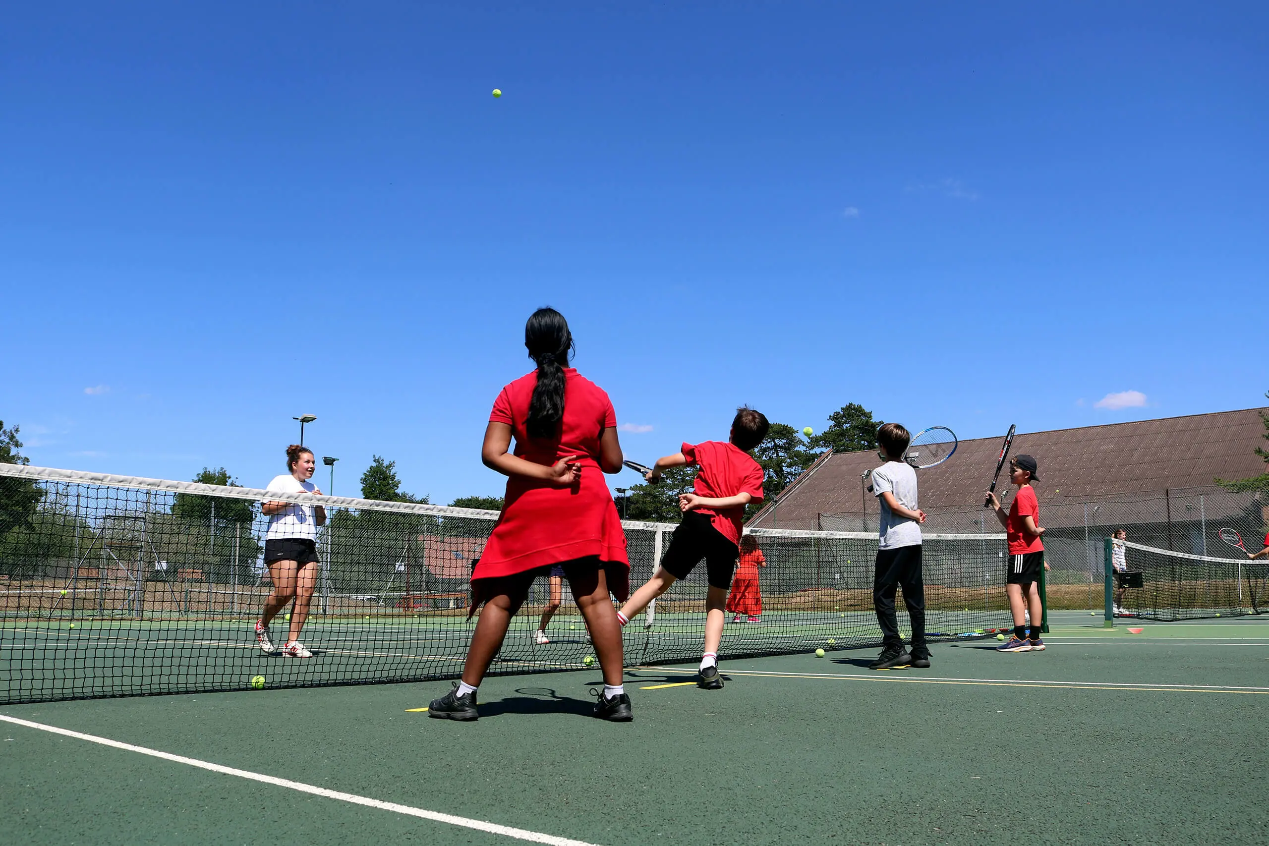 Students at St Swithun's School for girls in Hampshire playing sport with local primary school