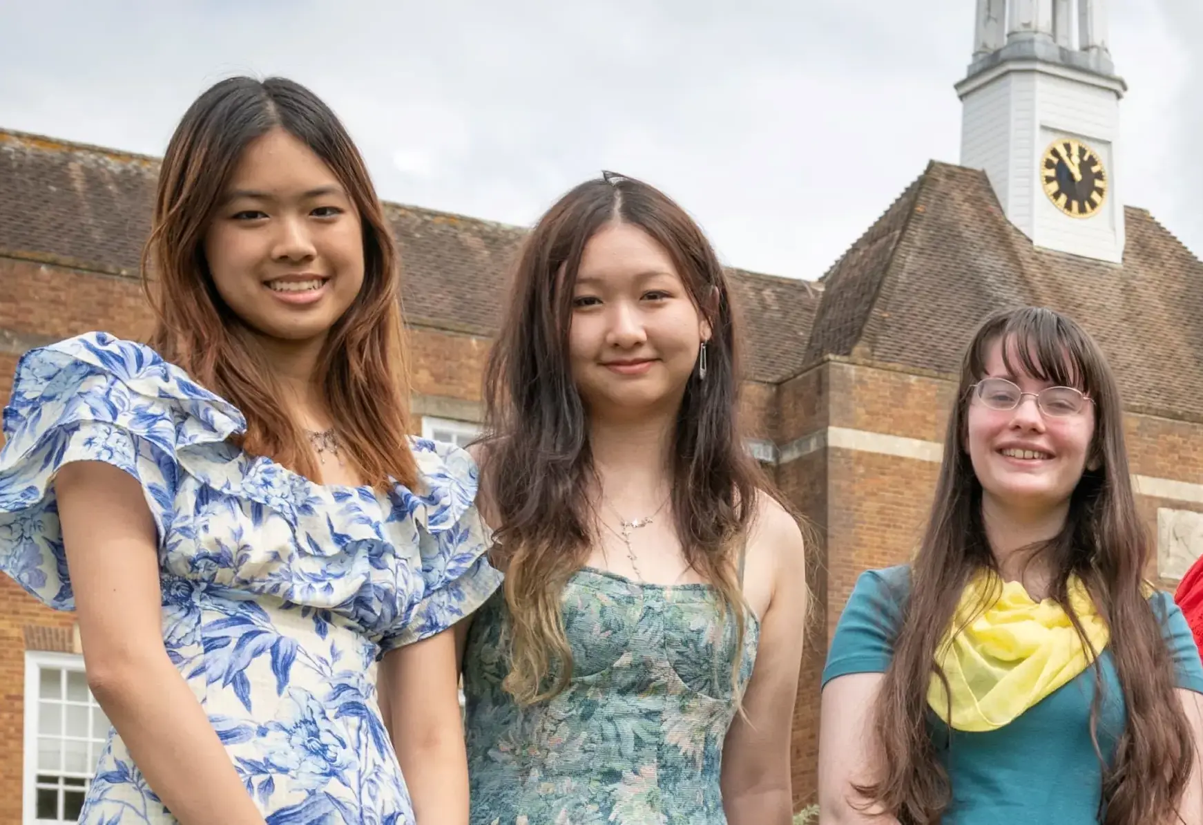 Three students smiling