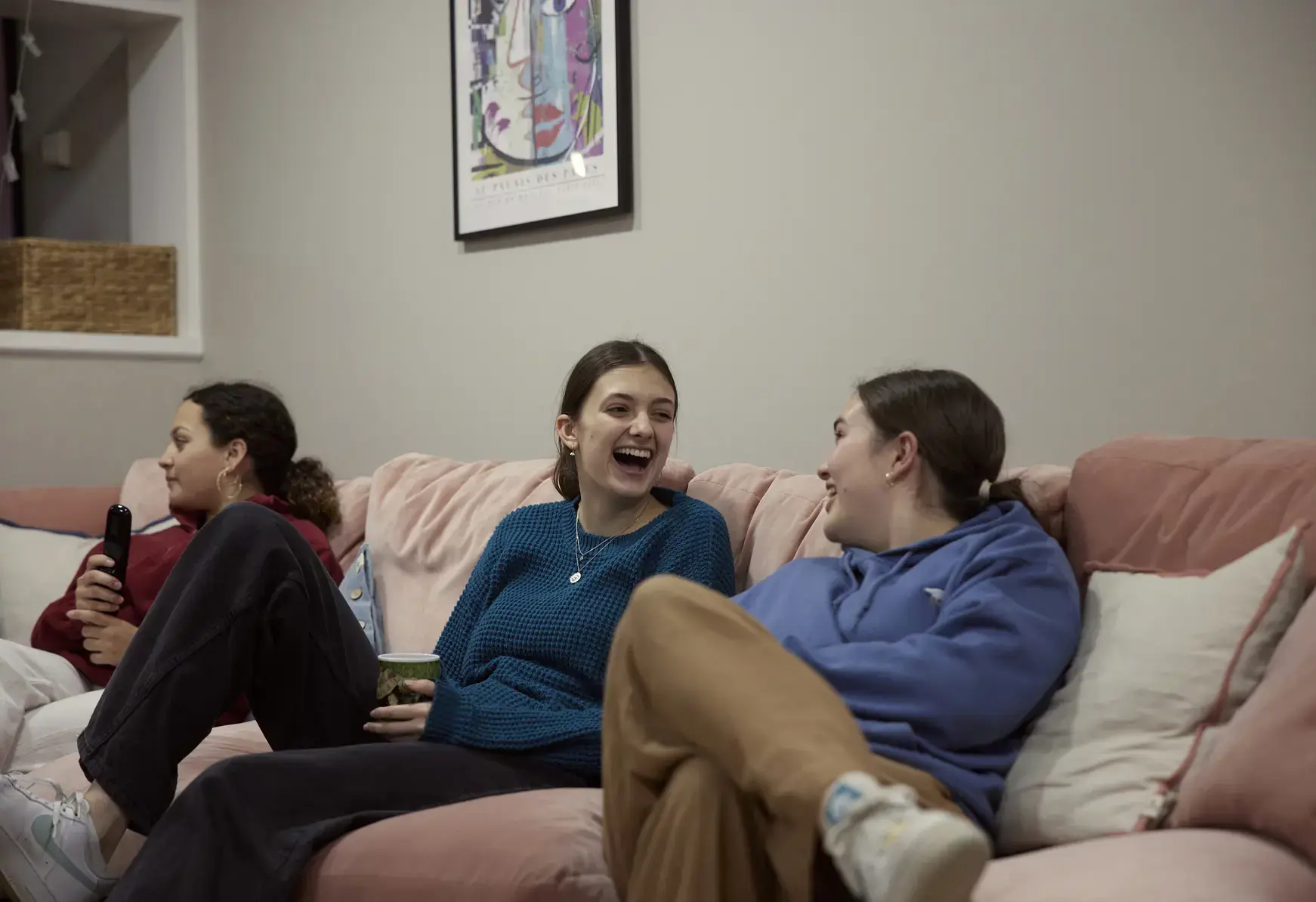 Sixth form students at St Swithun's School for girls in Hampshire in a kitchen laughing Sixth form students at St Swithun's School for girls in Hampshire on a sofa laughing