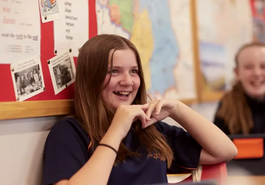 Girl smiling in lesson at St Swithun's School, an independent school in Winchester in Hampshire